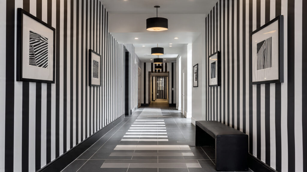 Stunning Wall Decor Painting: 13 Ideas to Transform Your Home a modern hallway with black and white striped pain