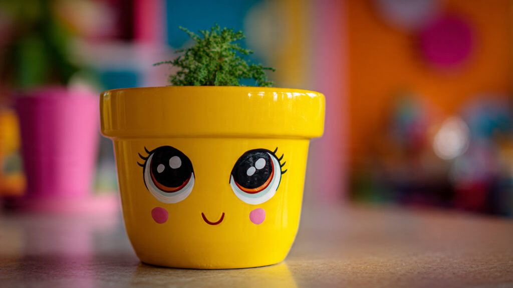 25 Creative Flower Pot Painting Ideas for DIY Garden Décor cute cartoon face painted flower pot bright yellow
